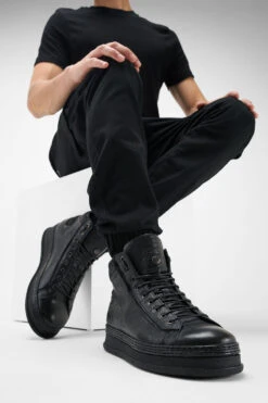 COLE Rugged-black Welted Distressed High Sneakers. 28 COLE Rugged-black Welted Distressed High Sneakers. -Untamedstreet Shop Men wearing COLE black welted distressed high leather sneakers 245020