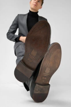 YALE Matte-black Welted Oxford Lace Up Boots. 14 YALE Matte-black Welted Oxford Lace Up Boots. -Untamedstreet Shop Model wearing YALE tuxedo black welted derby lace up leather boots 242020